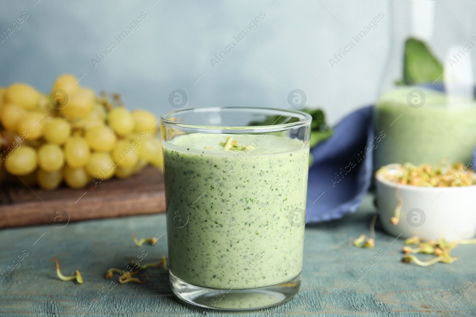 Photo of Green buckwheat smoothie on light blue wooden table