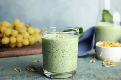 Green buckwheat smoothie on light blue wooden table