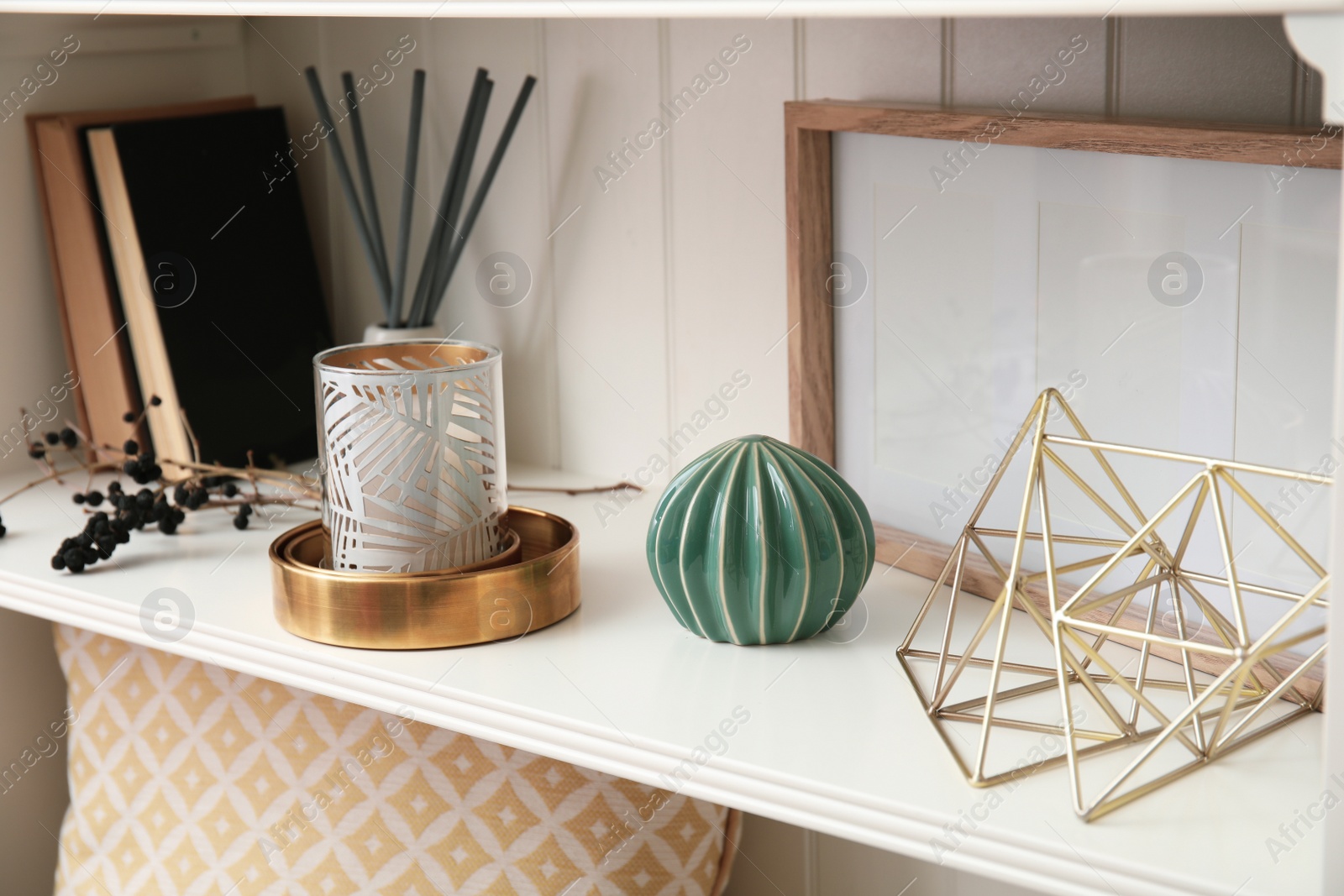 Photo of White shelving unit with books and different decorative stuff