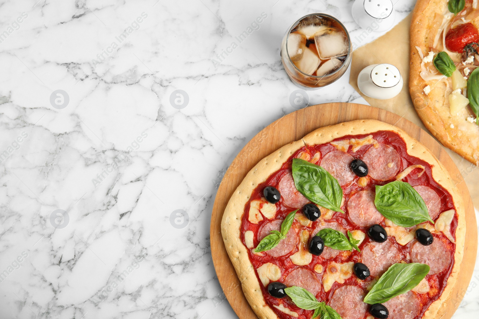 Photo of Delicious homemade pita pizza and cold drink on white marble table, flat lay. Space for text