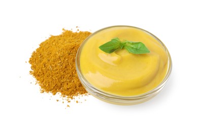 Photo of Bowl with tasty curry sauce, powder and basil isolated on white