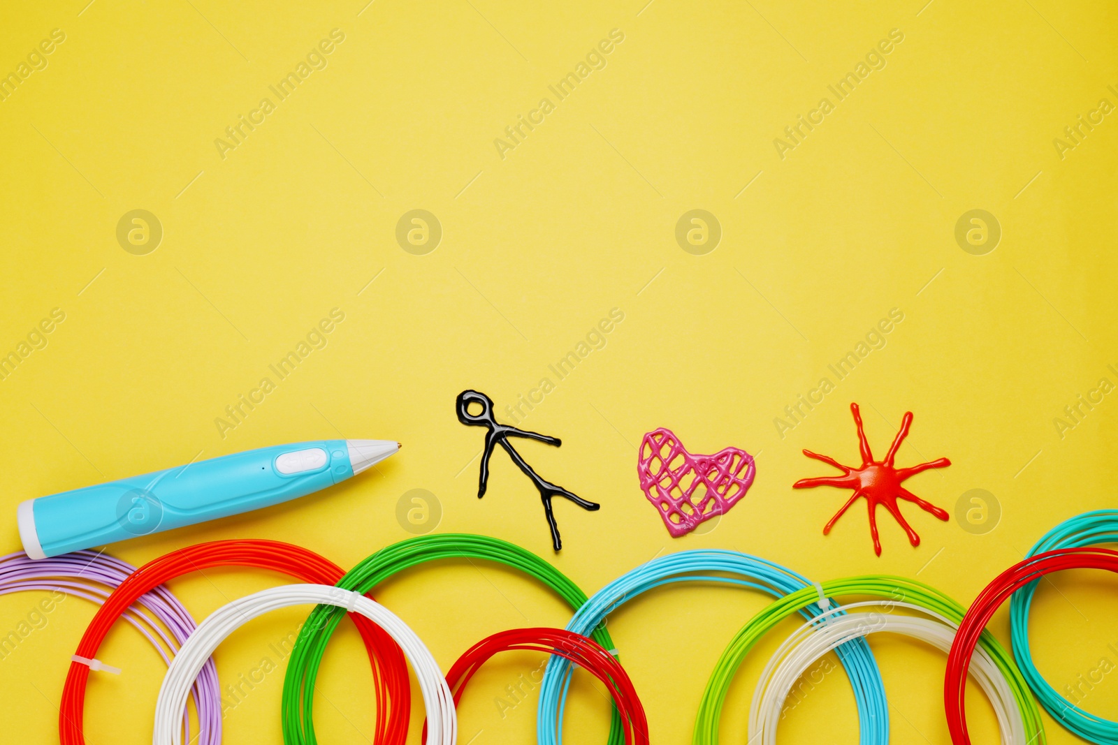 Photo of Stylish 3D pen, colorful plastic filaments and different figures on yellow background, flat lay. Space for text