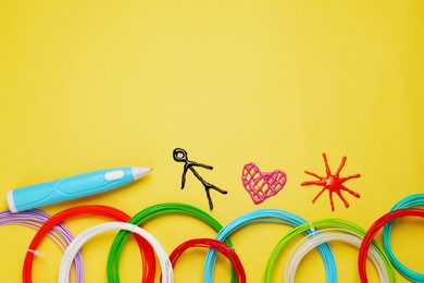 Photo of Stylish 3D pen, colorful plastic filaments and different figures on yellow background, flat lay. Space for text