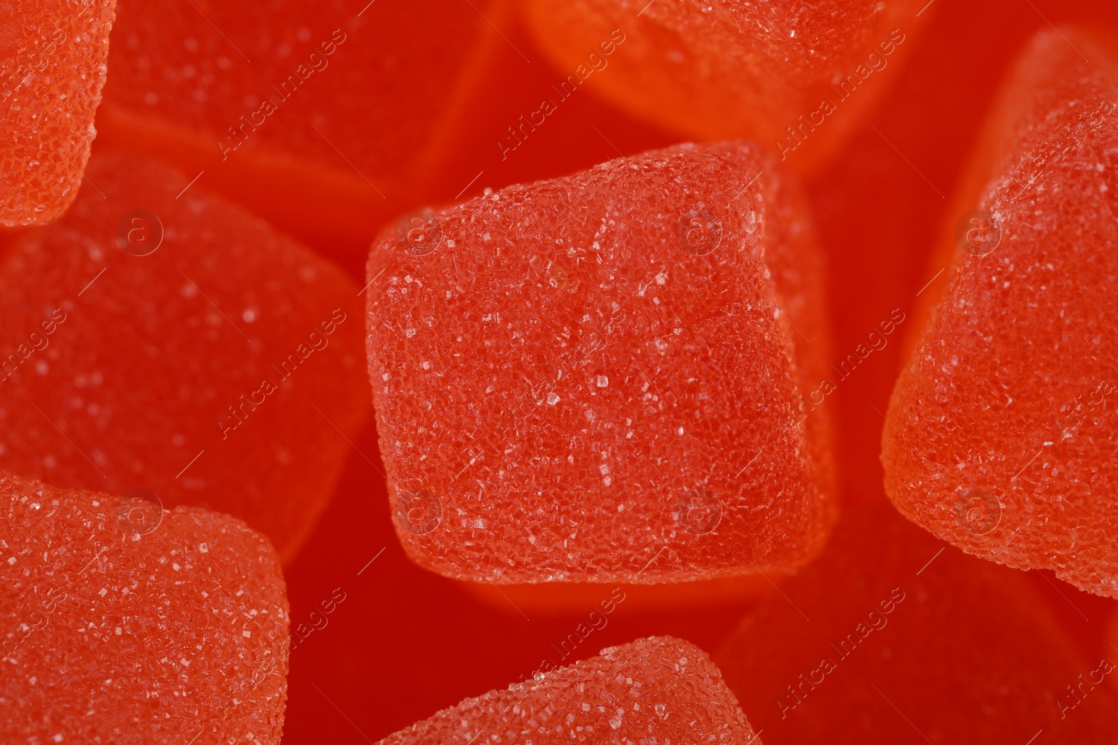 Photo of Tasty orange jelly candies as background, closeup