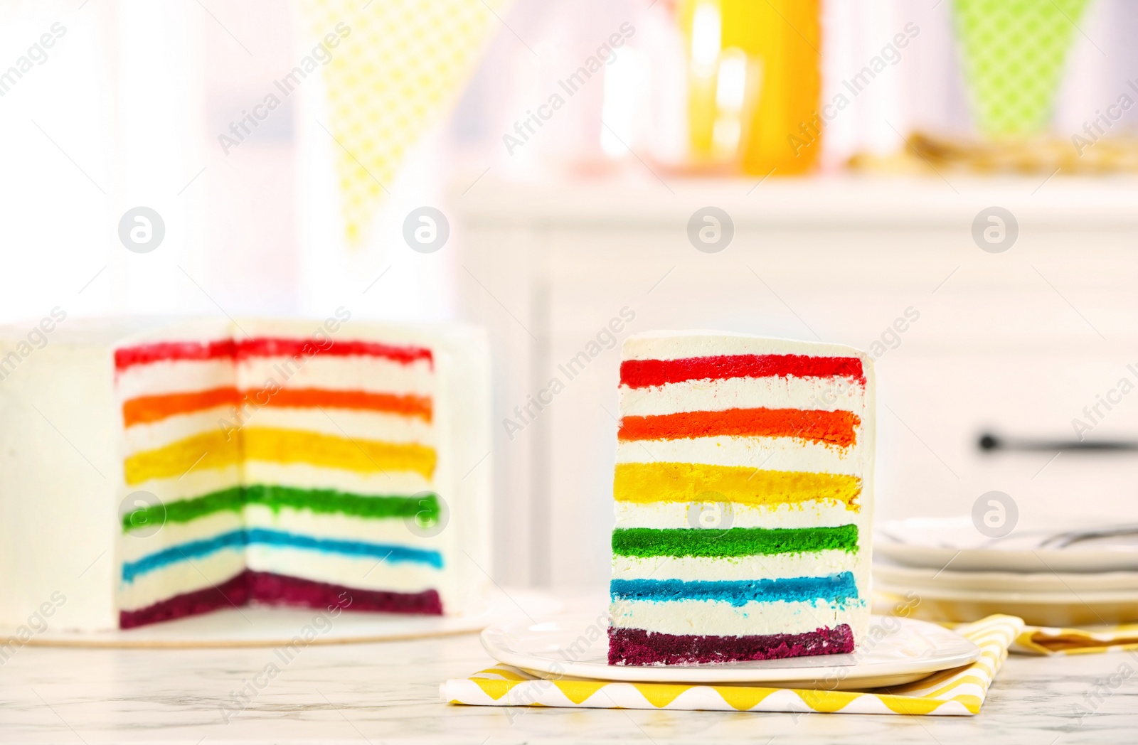 Photo of Delicious rainbow cake for party on table