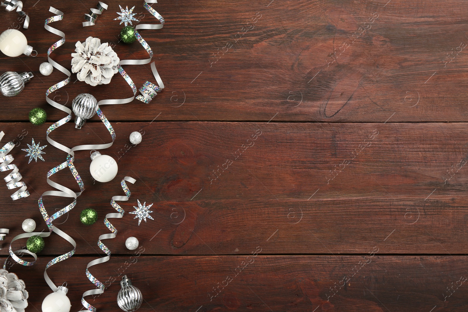 Photo of Flat lay composition with serpentine streamers on wooden background, space for text