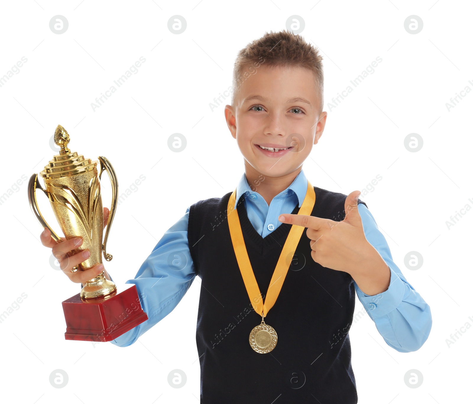 Photo of Happy boy in school uniform with golden winning cup and medal isolated on white