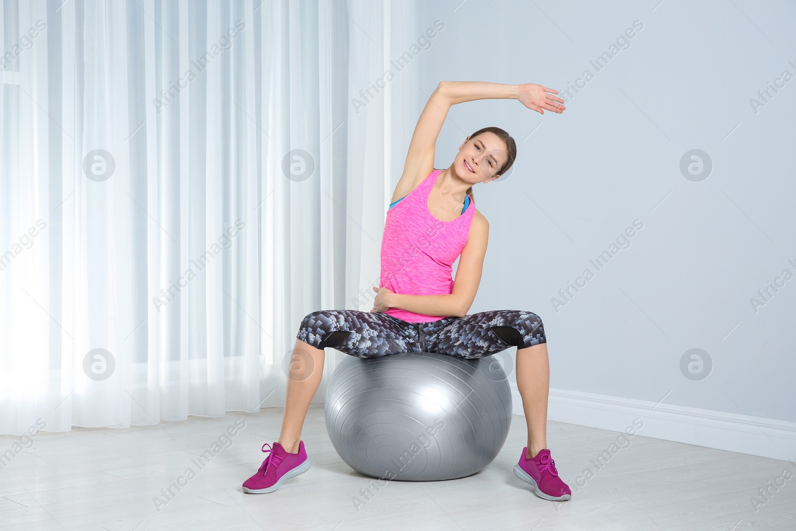 Photo of Young woman doing fitness exercises at home