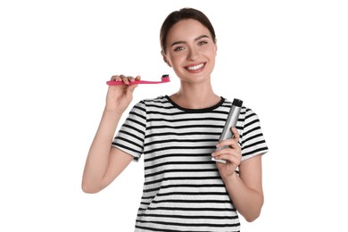 Photo of Young woman holding brush and tube with charcoal toothpaste on white background