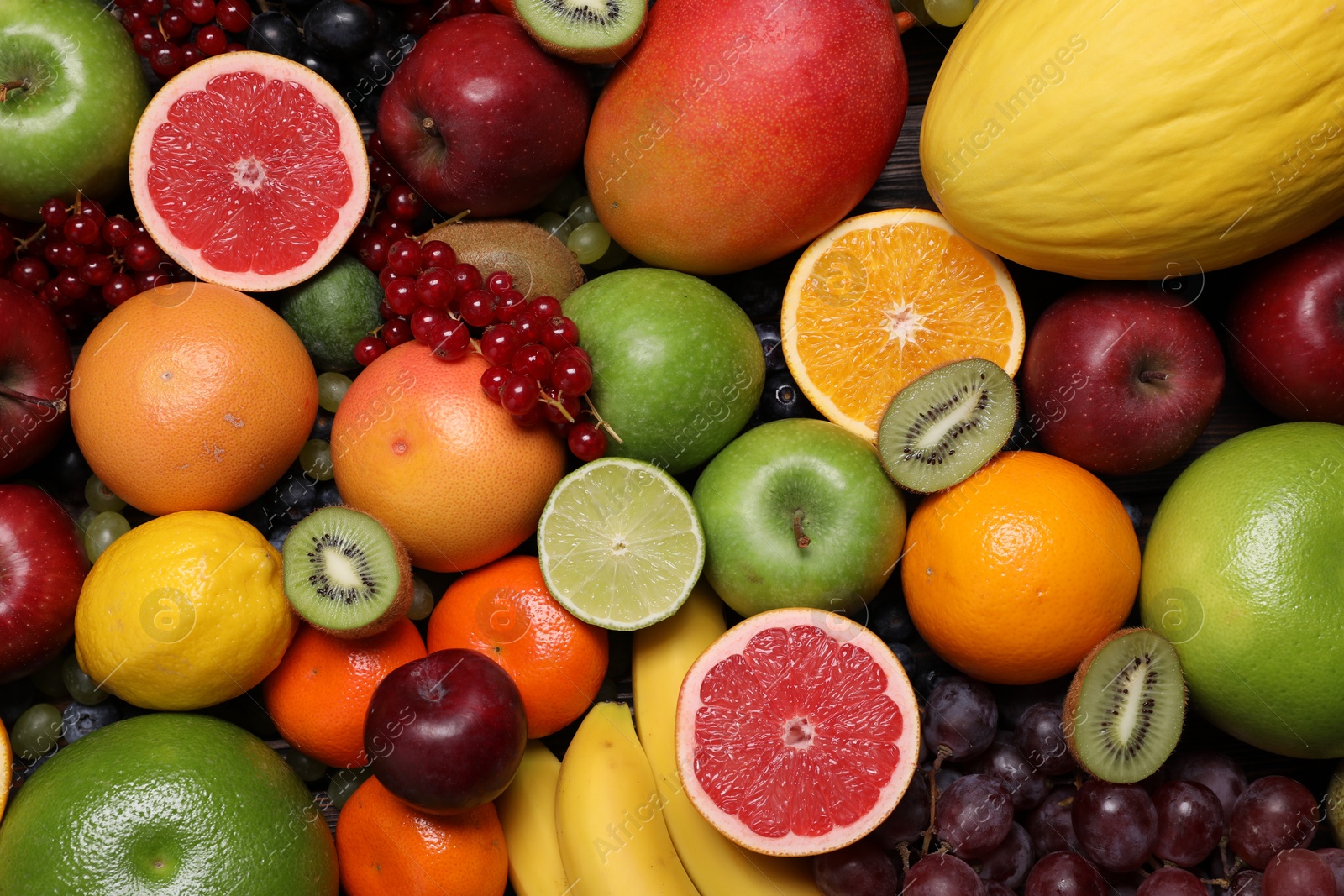 Photo of Different ripe fruits and berries as background, top view