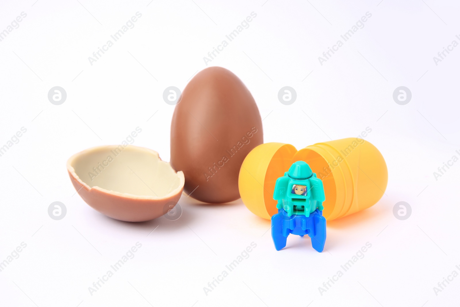 Photo of Slynchev Bryag, Bulgaria - May 24, 2023: Halves of Kinder Surprise Egg, plastic capsule and toy space rocket isolated on white