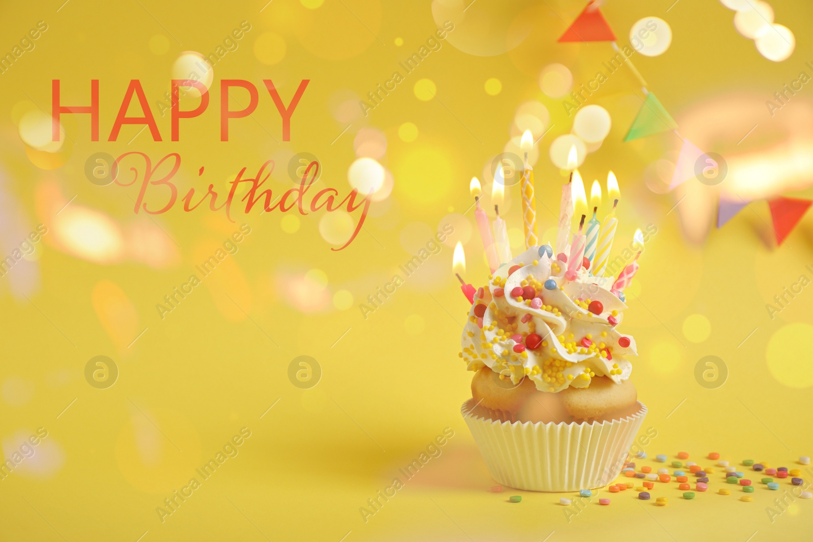 Image of Delicious cupcake with candles on yellow background. Happy Birthday