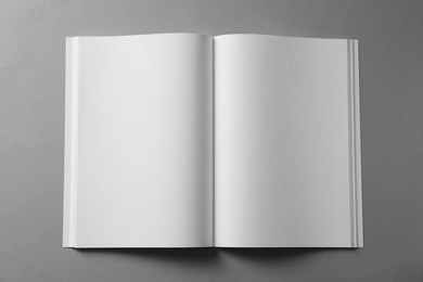 Photo of Open blank brochure on light grey background, top view