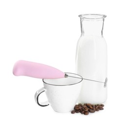 Pink mini mixer (milk frother), cup, coffee beans and bottle isolated on white