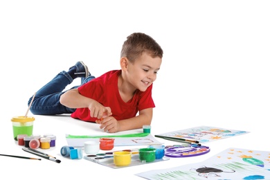 Photo of Cute child painting picture on white background