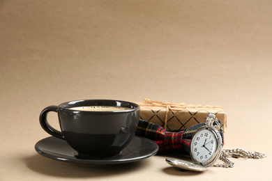 Photo of Composition with coffee, bow tie and watch on beige background. Happy father's day