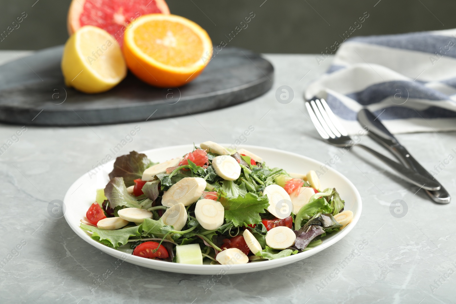 Photo of Delicious carrot salad served on grey table