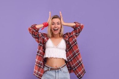 Photo of Portrait of excited hippie woman on purple background