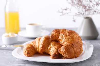 Photo of Tasty breakfast. Fresh croissants on grey table, closeup