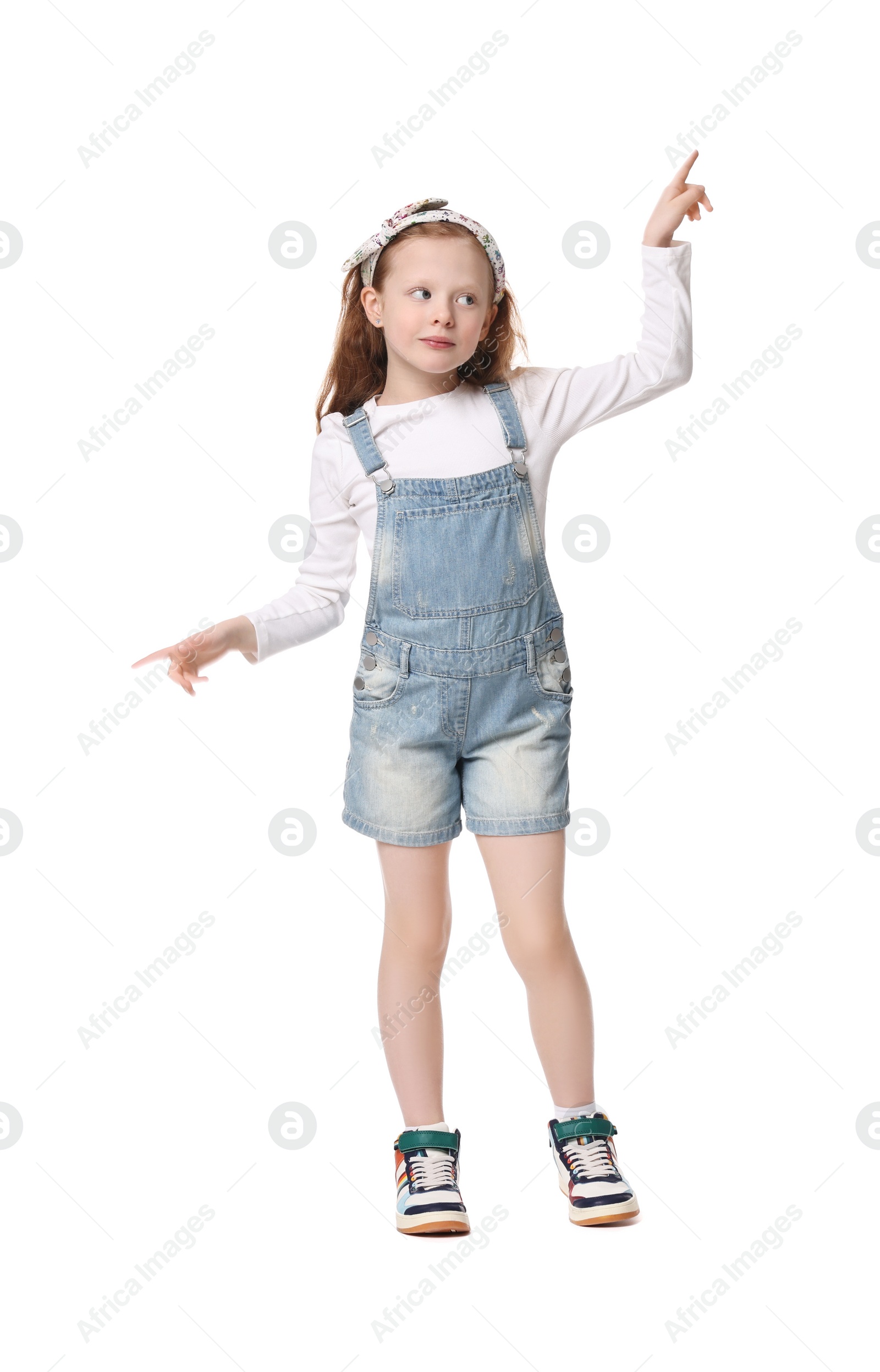 Photo of Cute little girl dancing on white background