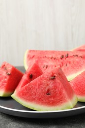 Photo of Delicious fresh watermelon slices on grey table, closeup