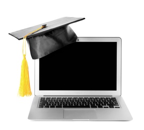 Photo of Graduation hat with gold tassel and laptop isolated on white. Space for text