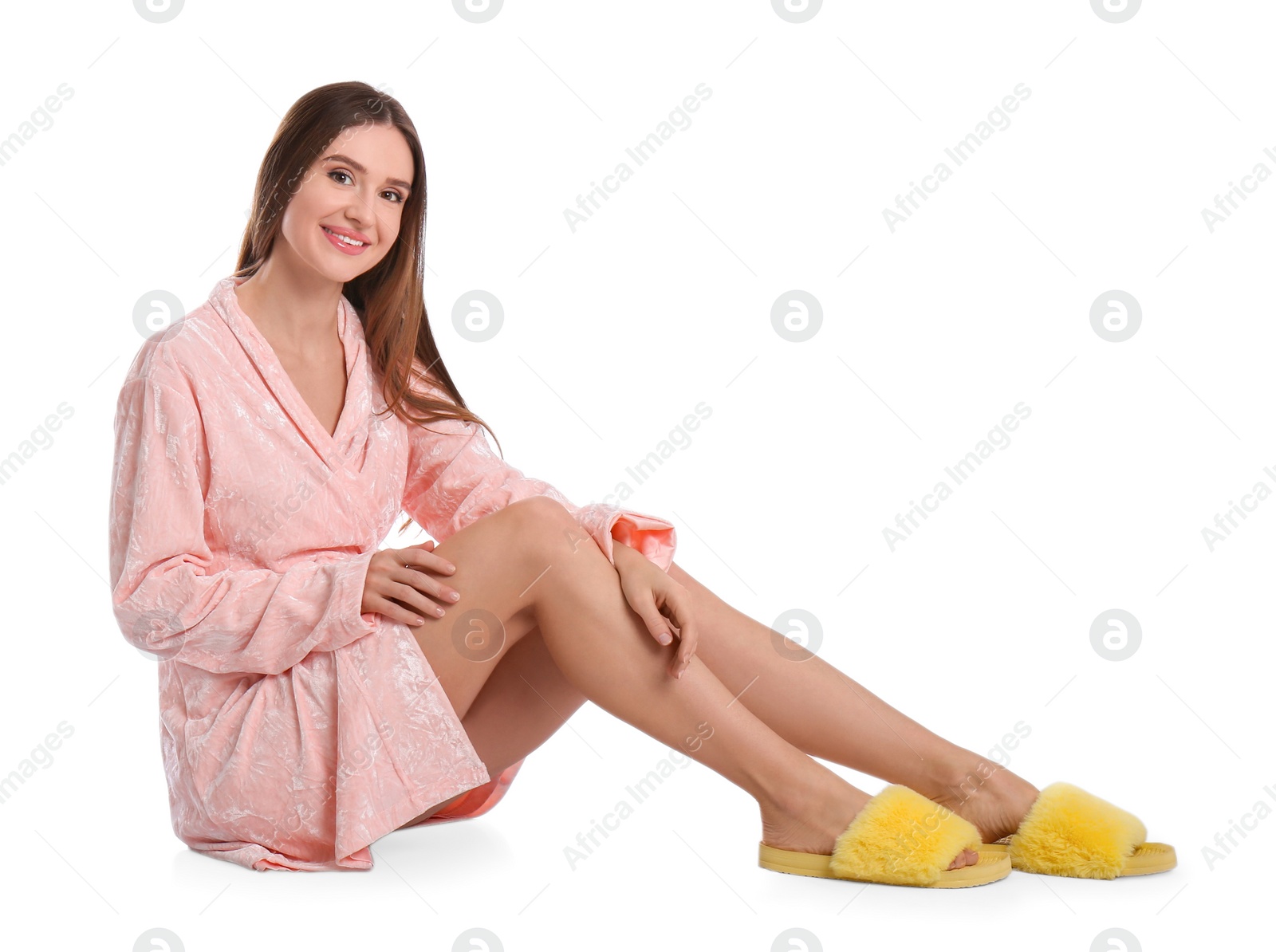 Photo of Young woman in bathrobe on white background