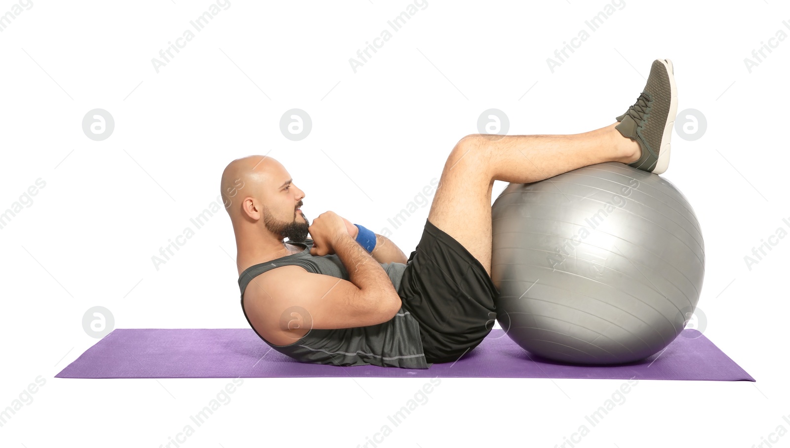 Photo of Overweight man doing exercise with fitness ball on white background