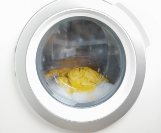 Photo of Washing machine with clothes, closeup. Laundry day