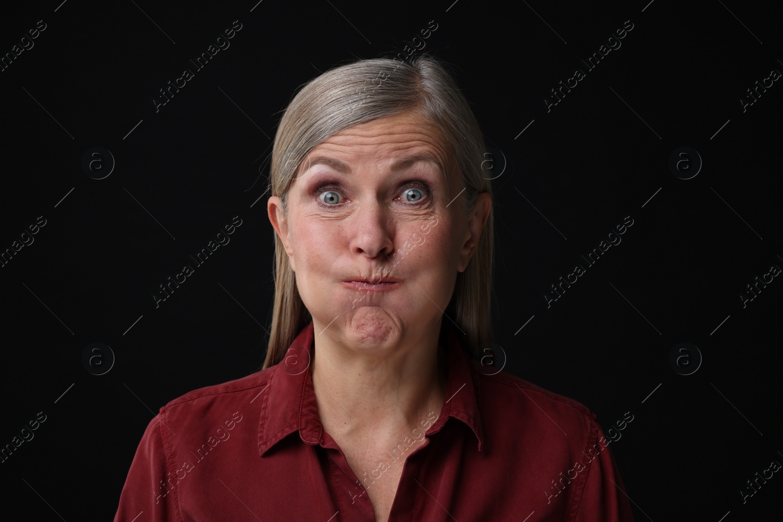 Photo of Personality concept. Portrait of emotional woman on black background