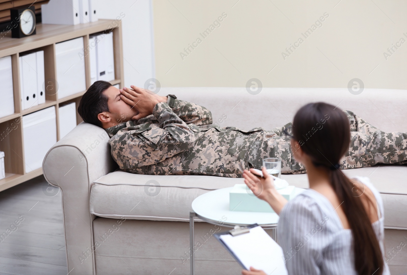 Photo of Psychotherapist working with male military officer in office