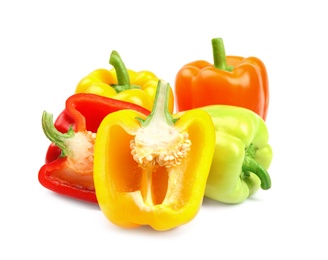 Whole and cut ripe bell peppers on white background