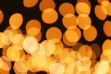 Photo of Beautiful golden lights on dark background. Bokeh effect