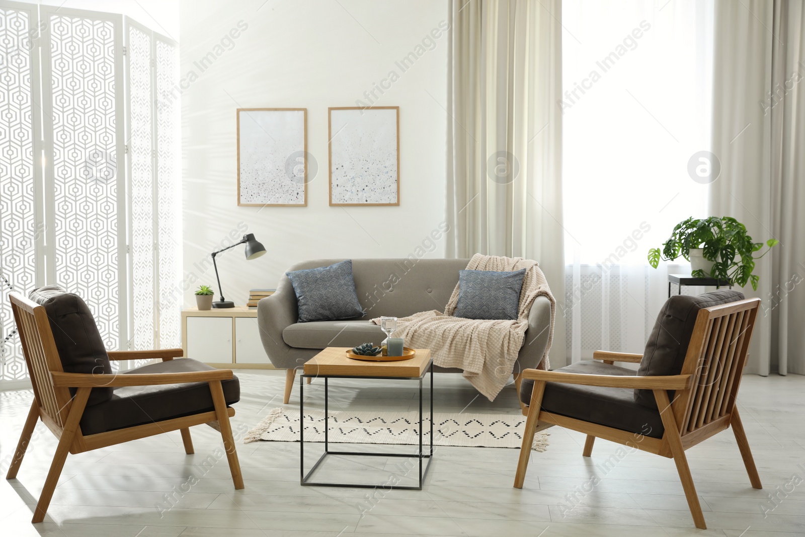 Photo of Modern living room interior with comfortable sofa and armchairs