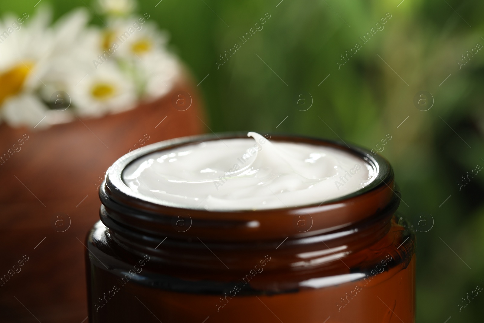 Photo of Jar of hand cream on blurred background, closeup