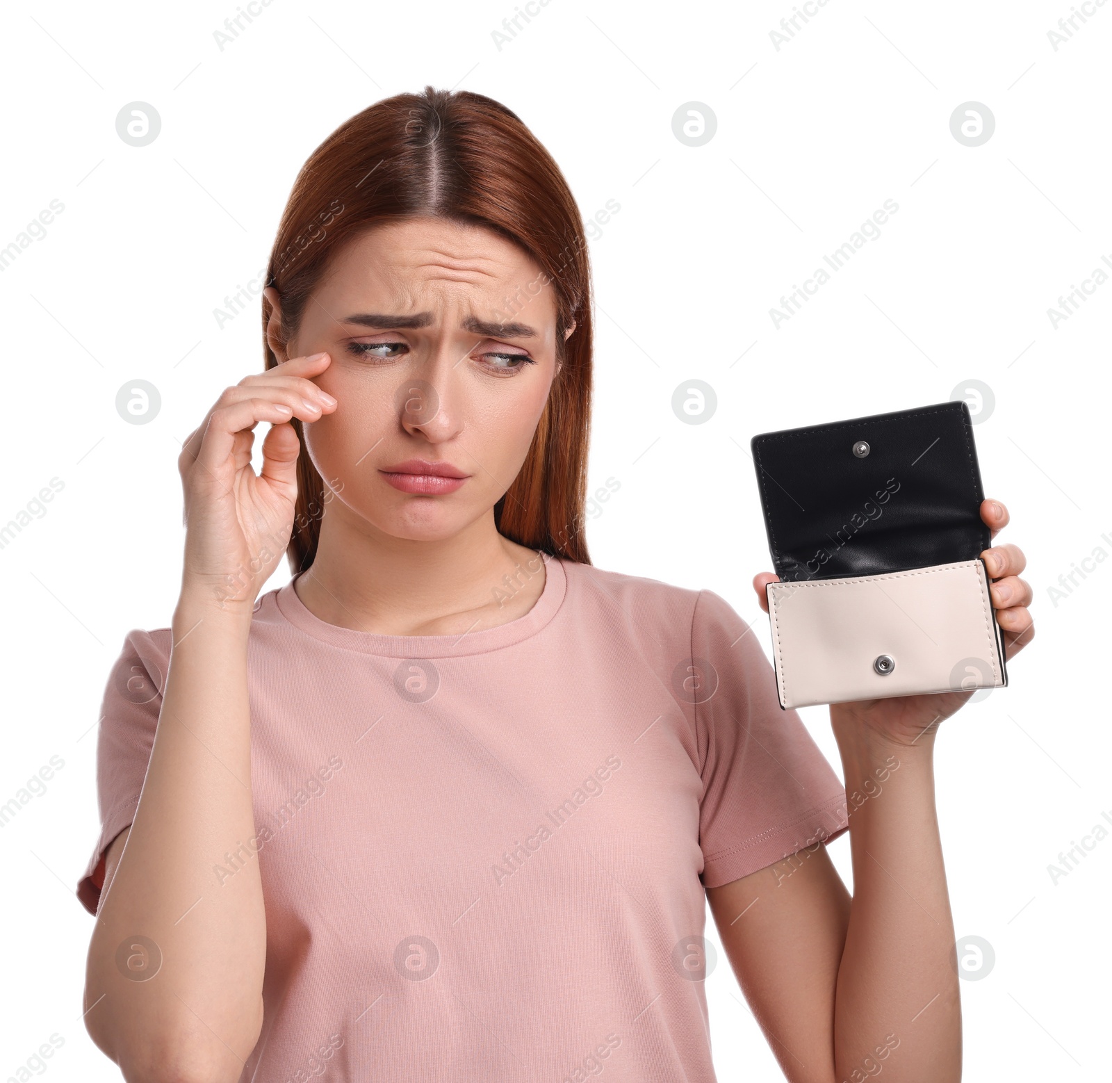 Photo of Upset woman with empty wallet on white background