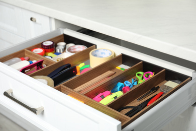 Photo of Different stationery in open desk drawer indoors