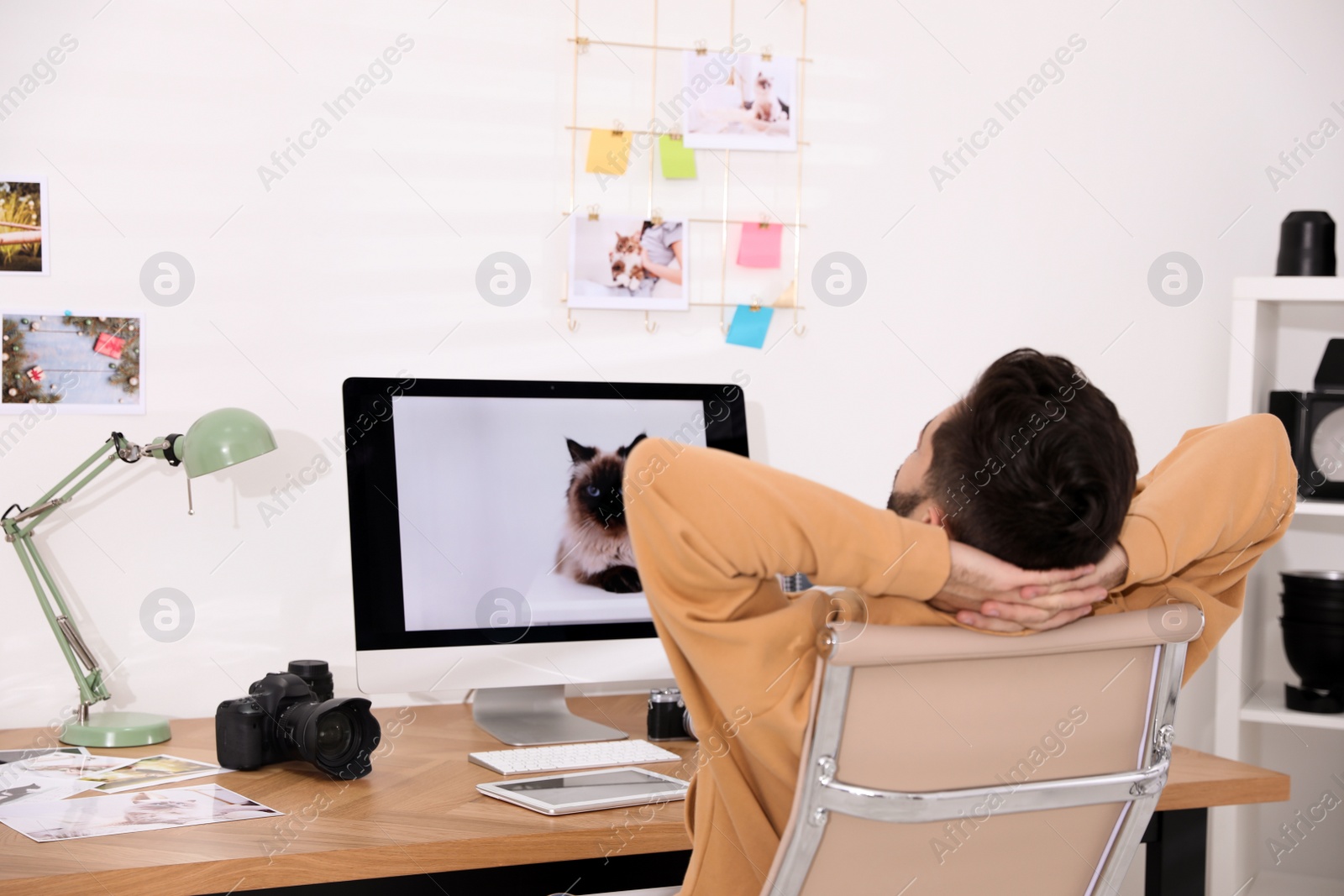 Photo of Professional photographer resting at workplace in office