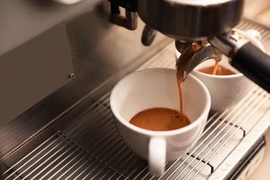 Photo of Preparing fresh aromatic coffee using modern machine, closeup. Space for text