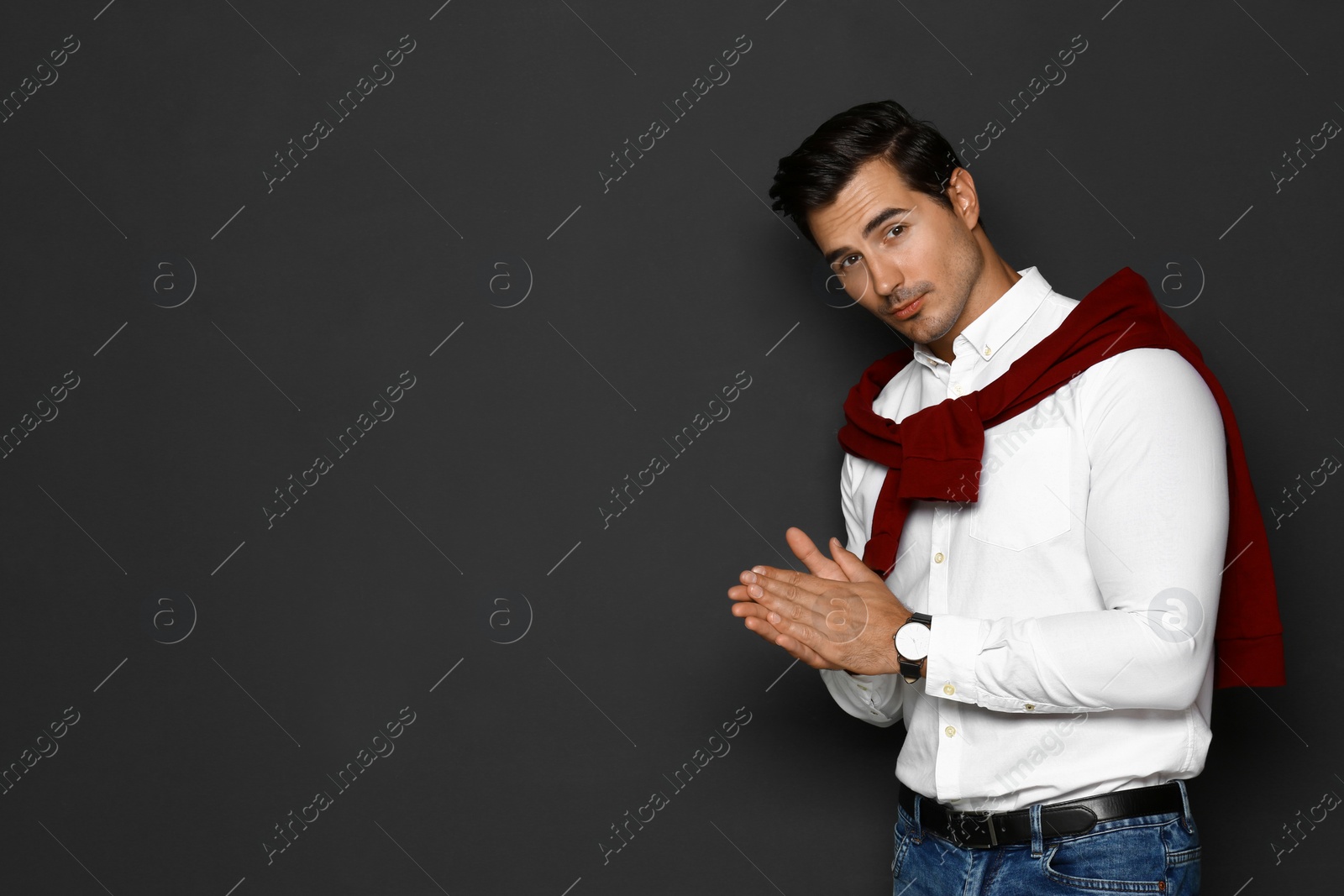 Photo of Portrait of handsome young man on dark background. Space for text