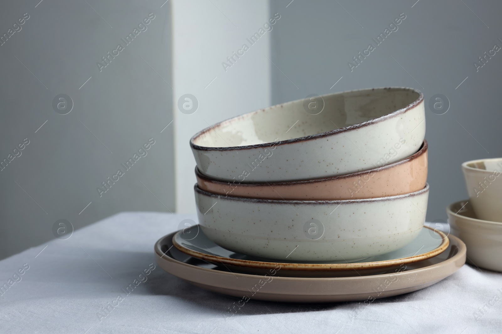 Photo of Stylish empty dishware on white table. Space for text
