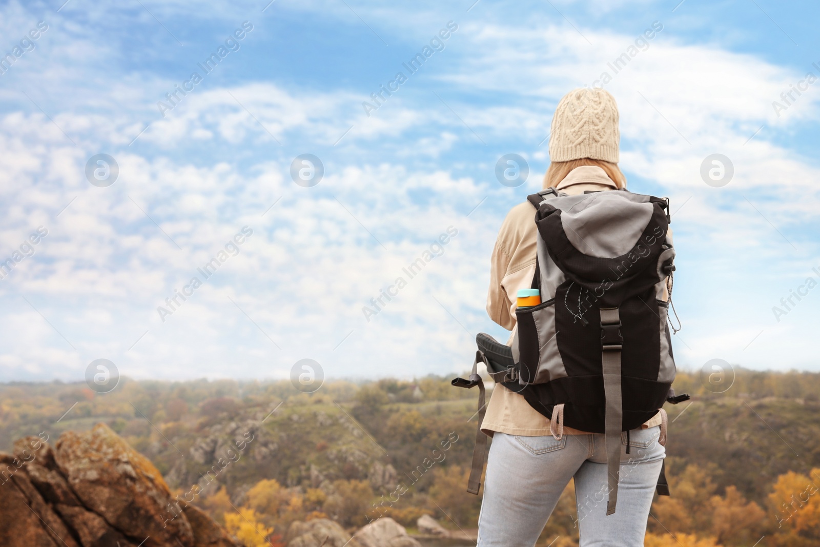 Photo of Traveler with backpack enjoying beautiful view on sunny day. Autumn vacation