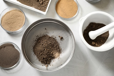 Laboratory equipment for pulverizing and sieving of soil samples on light table, flat lay