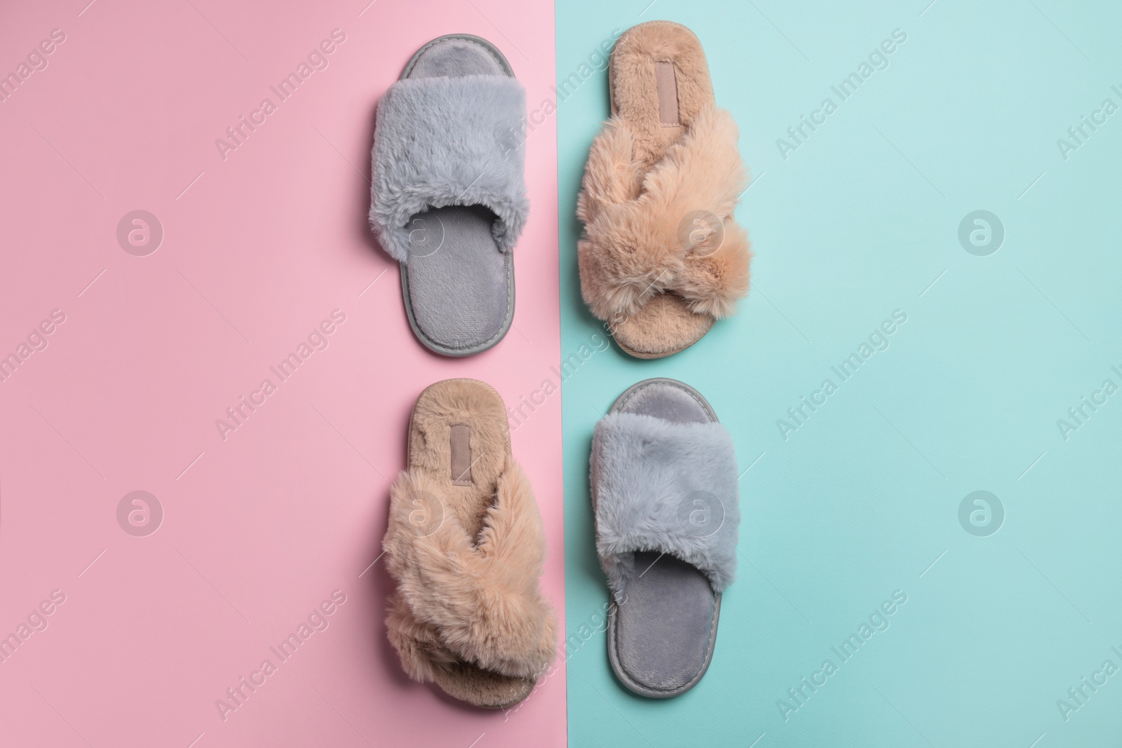 Photo of Different soft fluffy slippers on color background, flat lay