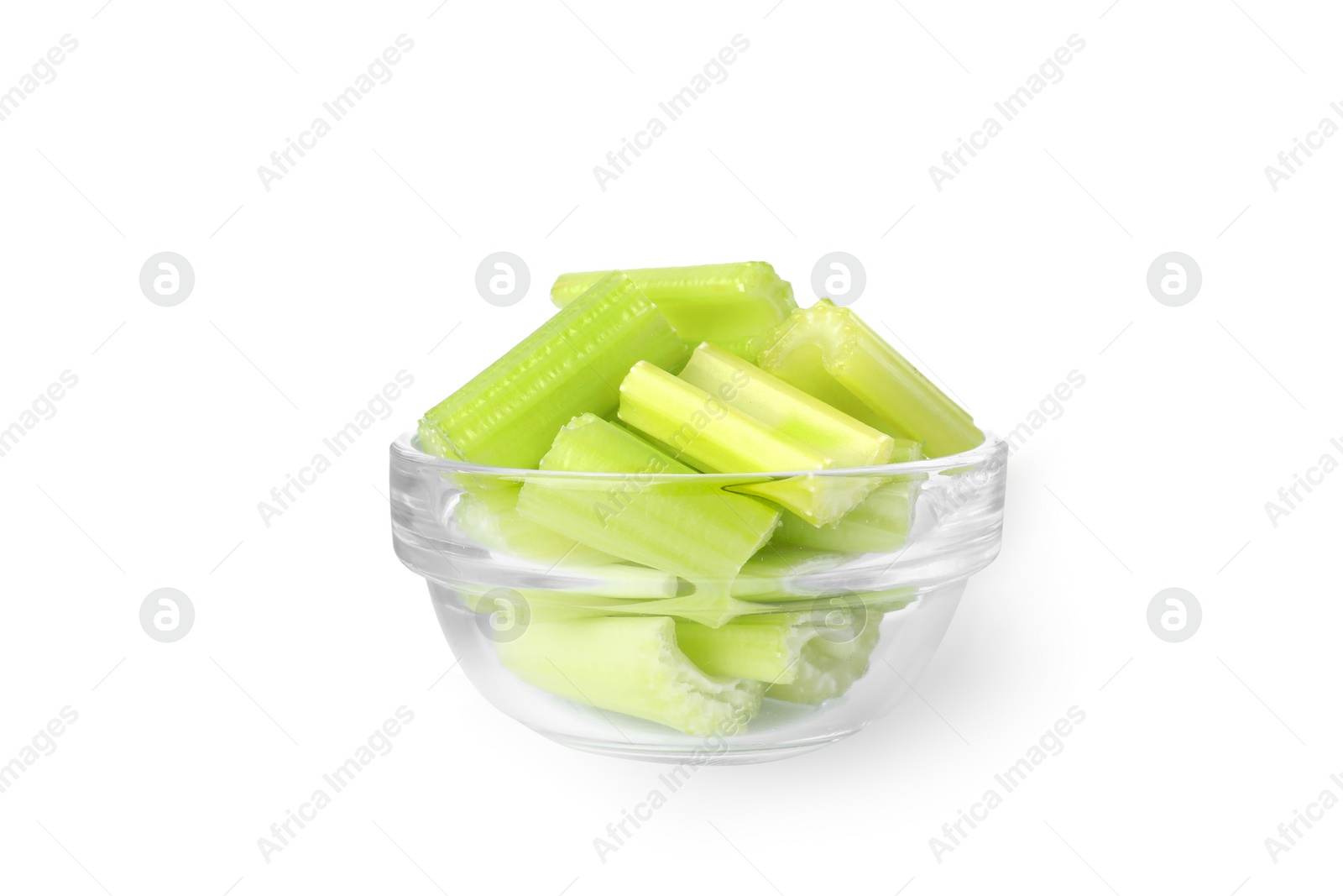 Photo of Glass bowl of fresh cut celery isolated on white