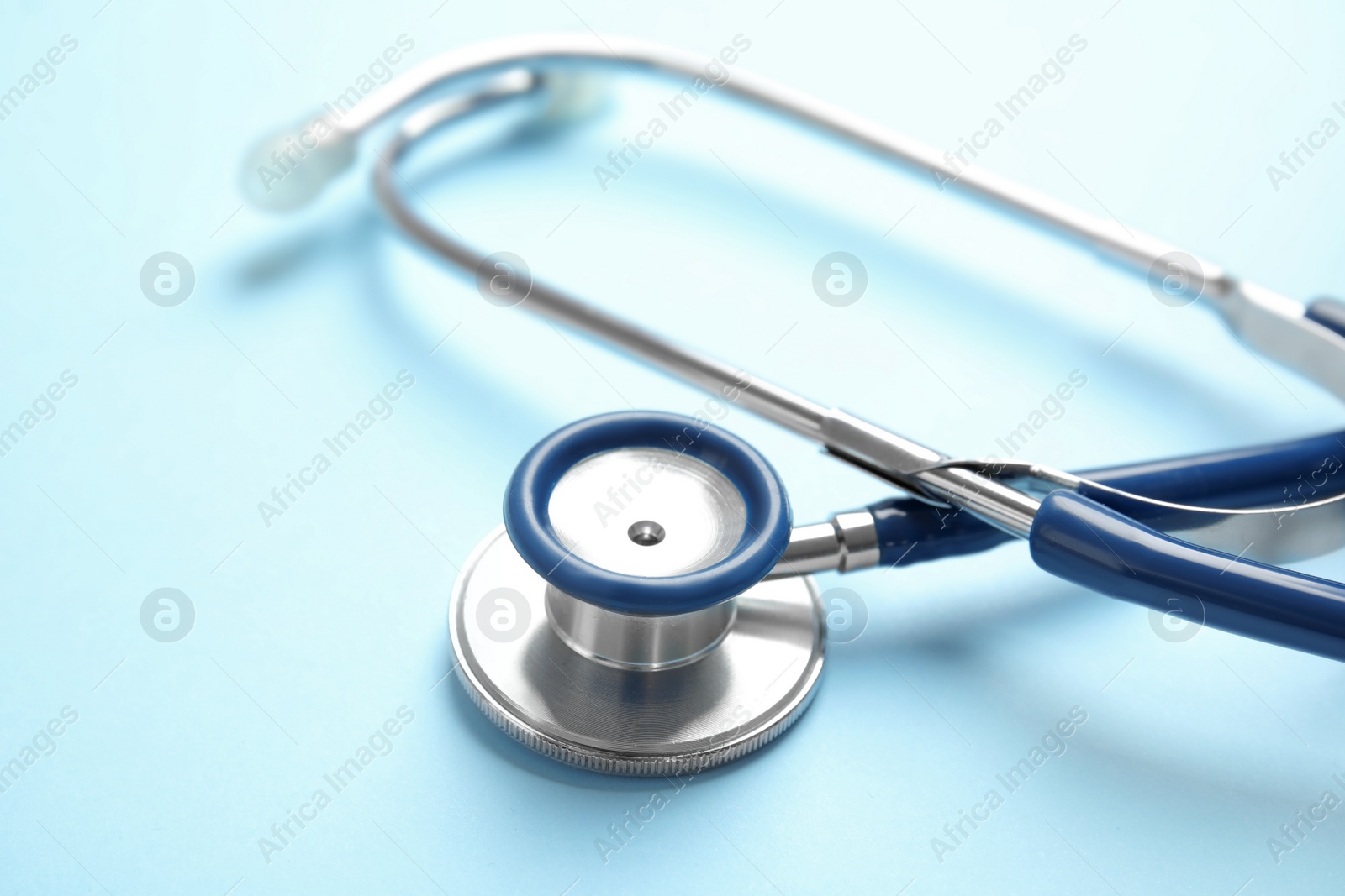 Photo of Stethoscope with space for text on color background, closeup. Medical tool