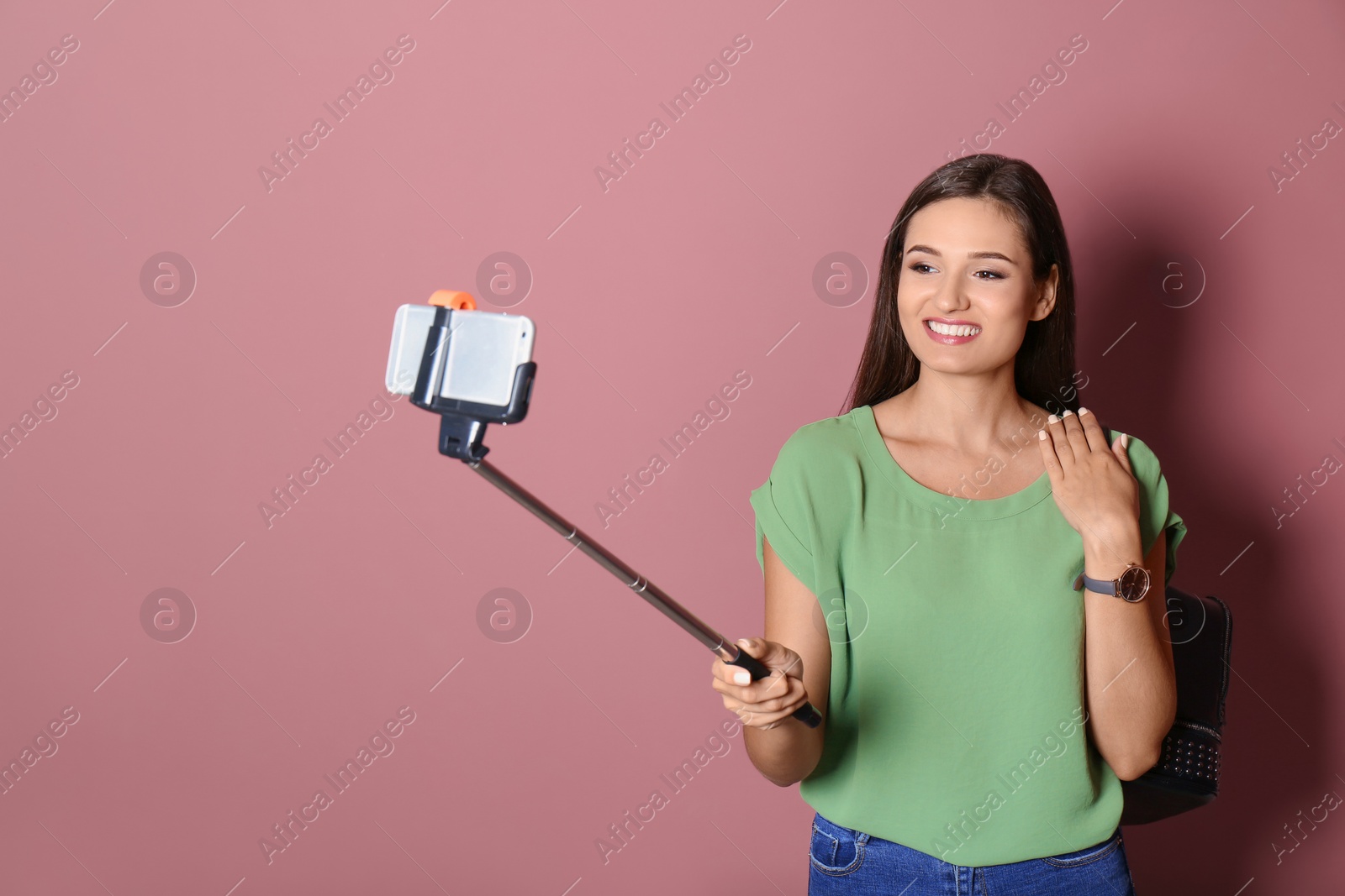 Photo of Young beautiful woman taking selfie against color background