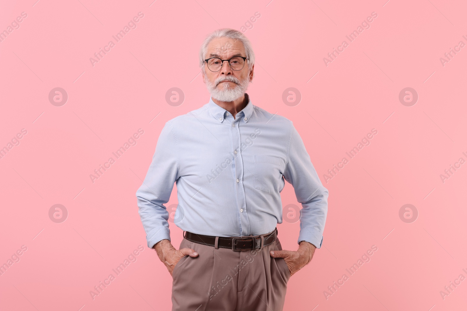 Photo of Portrait of stylish grandpa with glasses on pink background