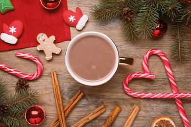 Photo of Flat lay composition with delicious hot chocolate and Christmas decor on wooden table