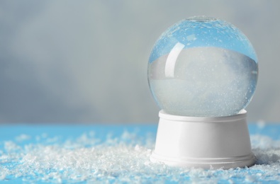 Photo of Magical empty snow globe on table. Space for text